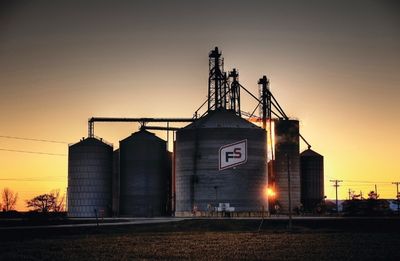 FS grain bins at sunset